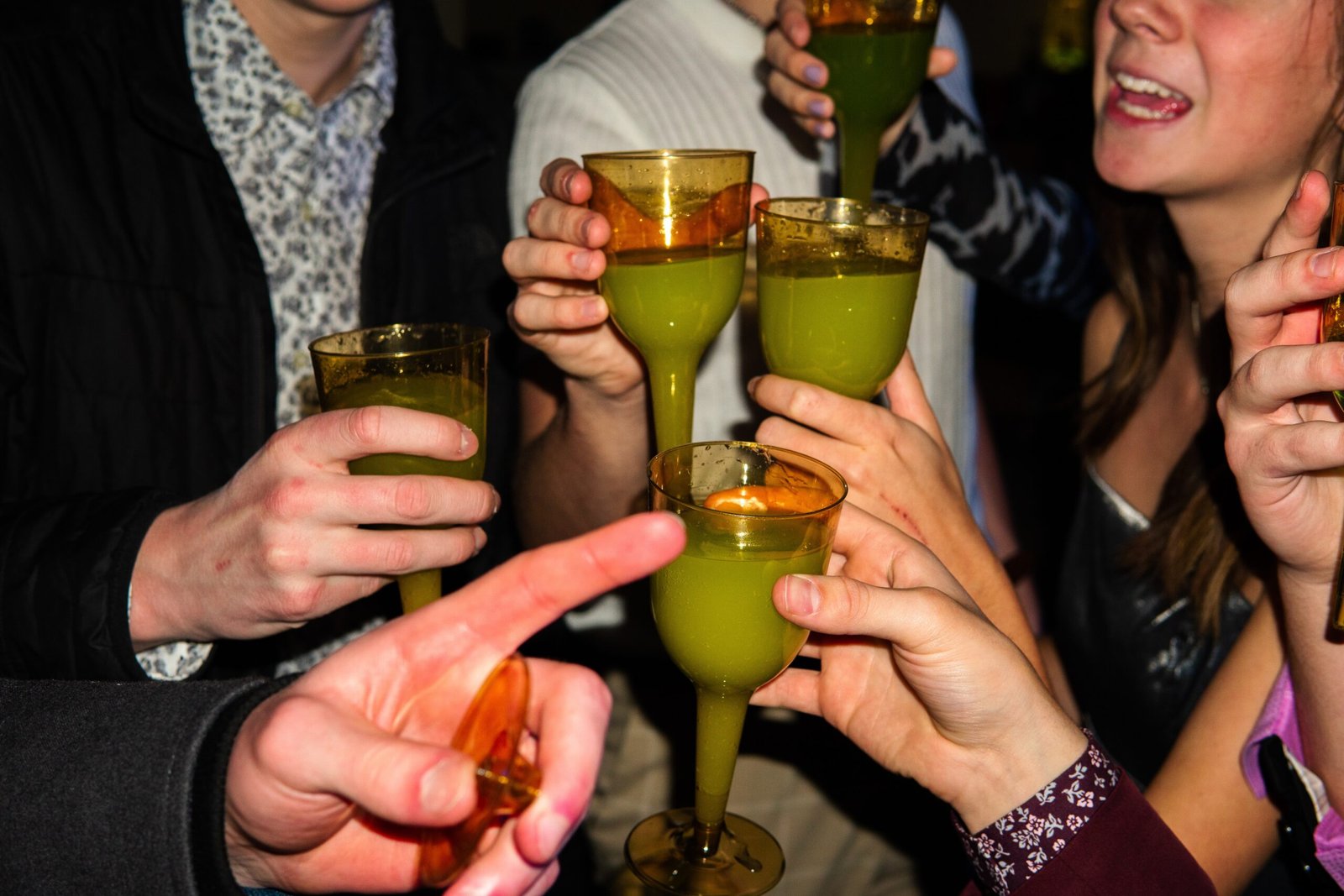 2 person holding drinking glass