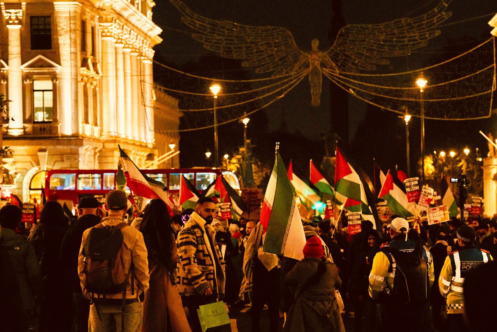 a large group of people holding flags in the street